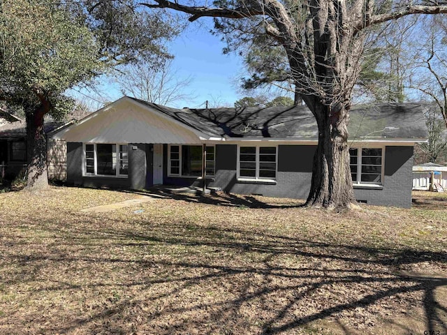 view of front of house with brick siding and crawl space