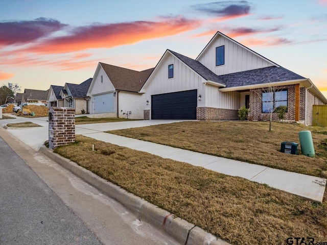 view of front of house featuring a yard and a garage