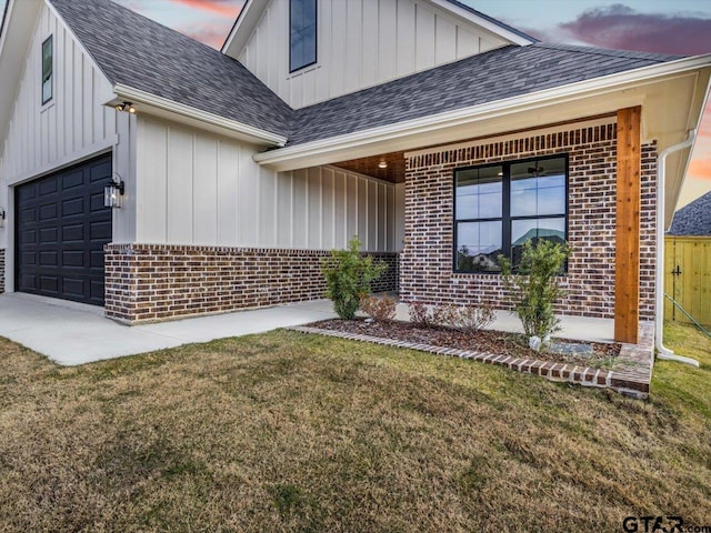 view of front of home with a lawn and a garage