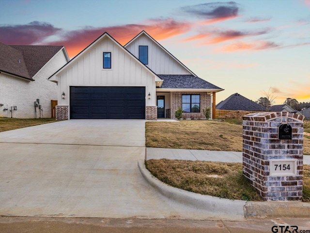 view of front facade with a garage and a yard