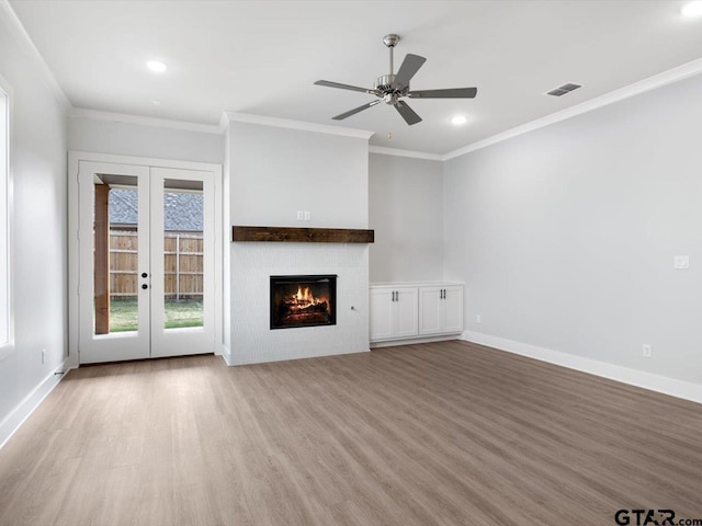 unfurnished living room featuring french doors, ceiling fan, crown molding, and wood-type flooring