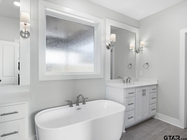 bathroom featuring vanity and a tub to relax in