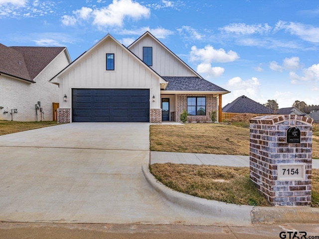 view of front of home featuring a garage and a front lawn