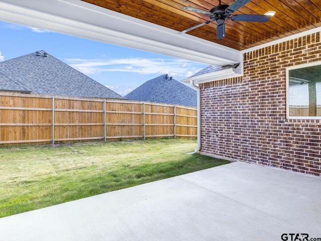 view of yard featuring ceiling fan and a patio