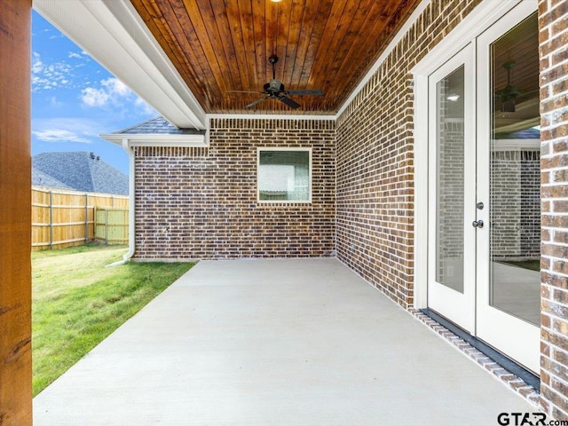 view of patio featuring ceiling fan, a mountain view, and french doors