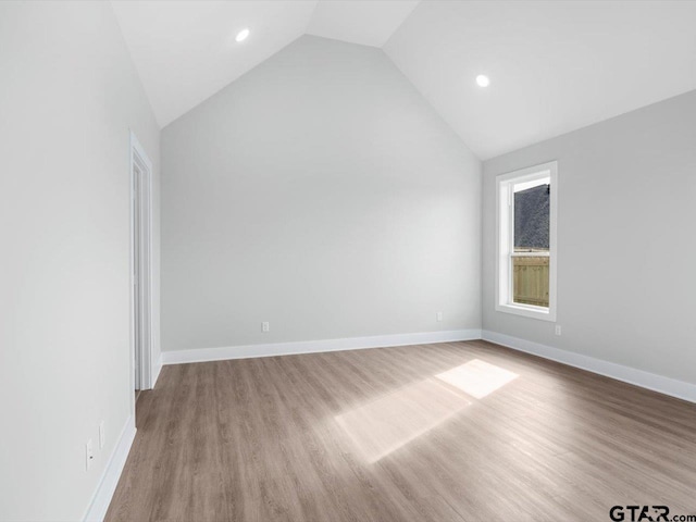 interior space with light hardwood / wood-style flooring and vaulted ceiling