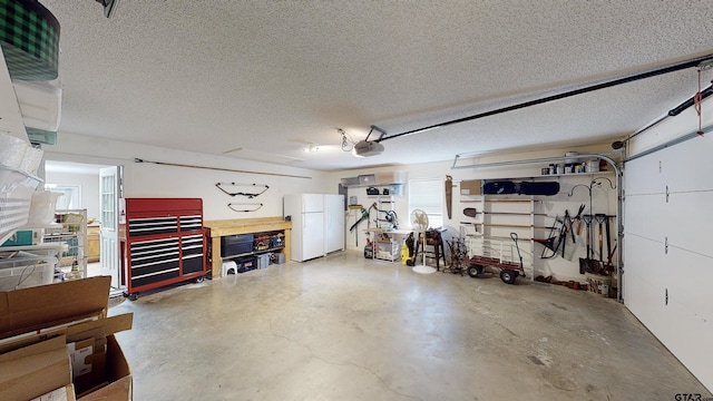 garage with freestanding refrigerator and a garage door opener