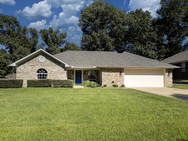 ranch-style house featuring a garage, roof with shingles, driveway, and a front lawn