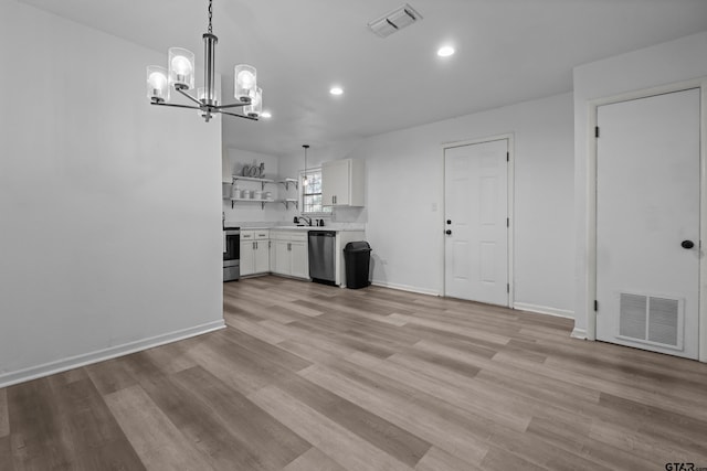 interior space featuring open shelves, appliances with stainless steel finishes, visible vents, and white cabinetry