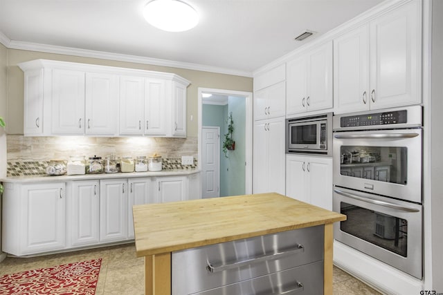 18058 Whispering Pines Rd, Flint, TX 75762 - kitchen with stainless steel appliances, a warming drawer, wooden counters, white cabinets, and crown molding