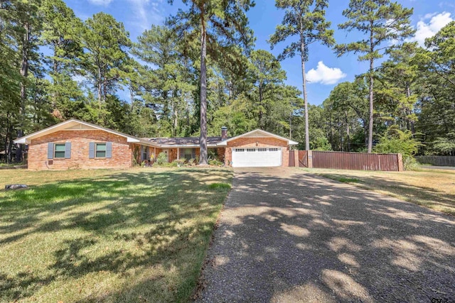 18058 Whispering Pines Rd, Flint, TX 75762 - view of front of house with brick siding, driveway, a garage, and view of scattered trees