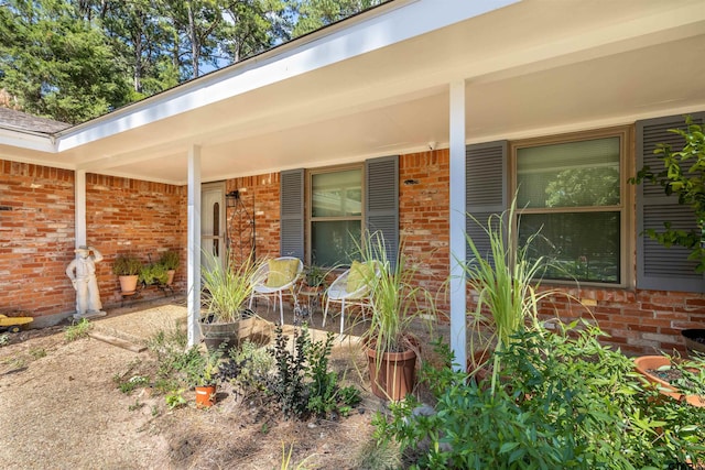 18058 Whispering Pines Rd, Flint, TX 75762 - doorway to property featuring brick siding and covered porch