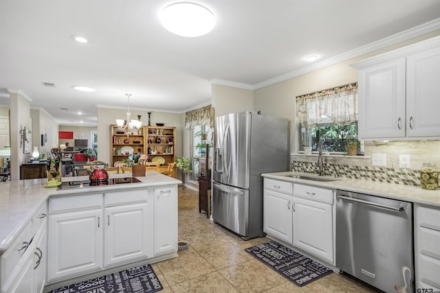 18058 Whispering Pines Rd, Flint, TX 75762 - kitchen featuring stainless steel appliances, crown molding, a chandelier, light countertops, and tasteful backsplash