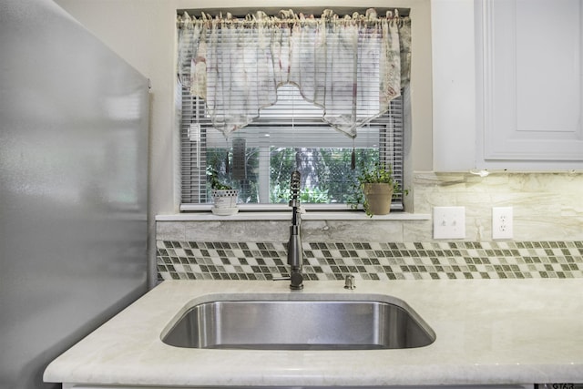 18058 Whispering Pines Rd, Flint, TX 75762 - kitchen view of tasteful backsplash, light countertops, and white cabinetry