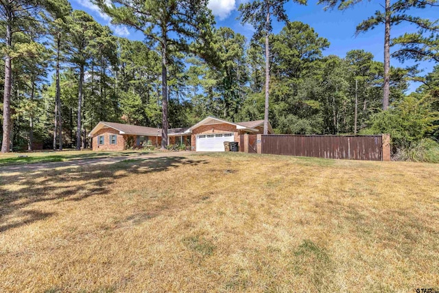18058 Whispering Pines Rd, Flint, TX 75762 - view of front of home with a garage and brick siding