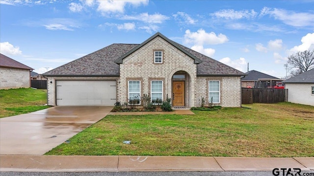 view of front of property featuring a garage and a front yard