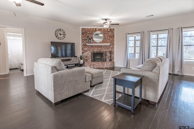 living room featuring a healthy amount of sunlight, dark hardwood / wood-style floors, and ceiling fan