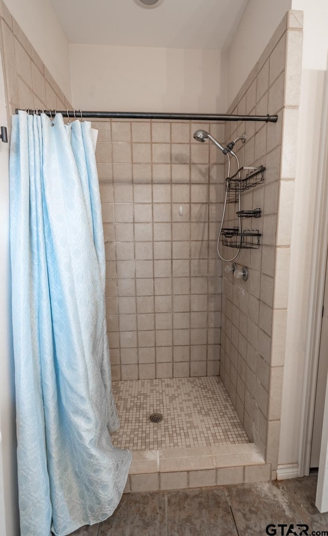 bathroom featuring tile patterned flooring and a shower with curtain