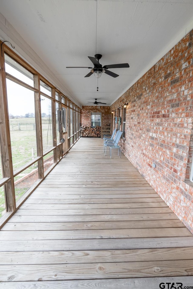 wooden deck featuring ceiling fan