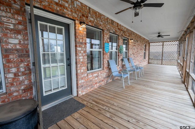 wooden deck with ceiling fan and a porch