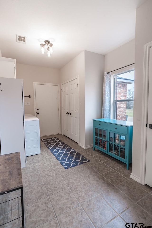 foyer with tile patterned floors and washer / clothes dryer