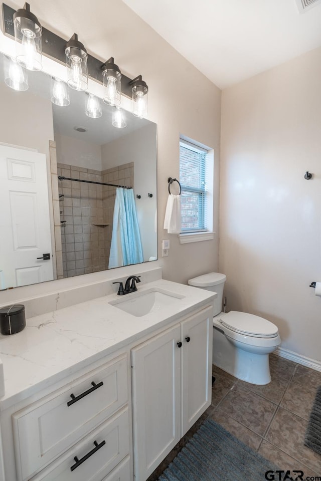 bathroom featuring vanity, curtained shower, tile patterned floors, and toilet