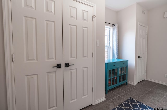 interior space featuring dark tile patterned flooring