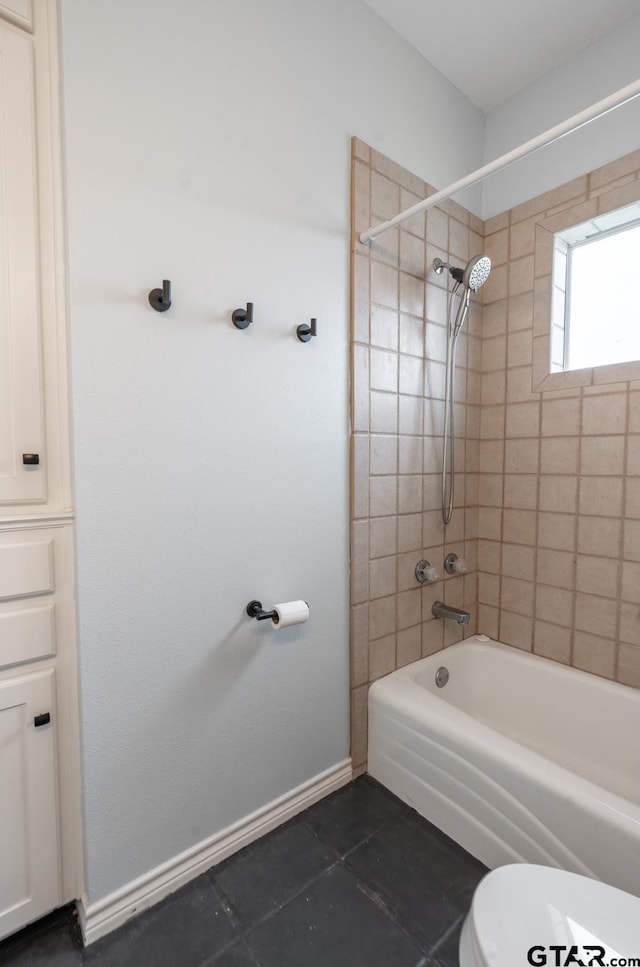 bathroom featuring toilet and tiled shower / bath combo