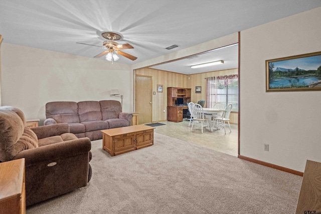 living room featuring light carpet and ceiling fan