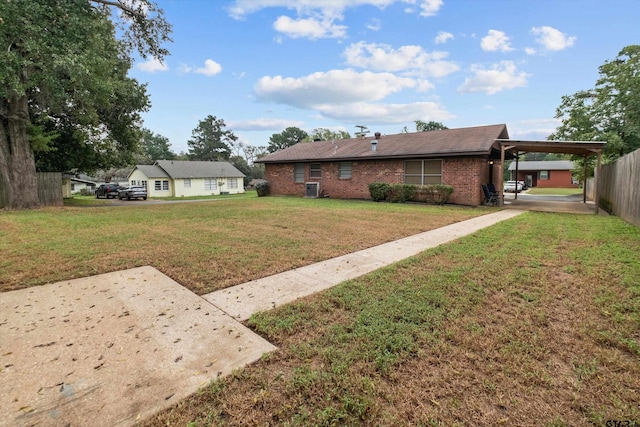 view of yard featuring central AC unit and a carport