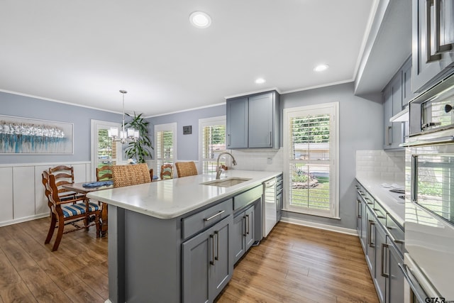 2600 Boldt Ave, Tyler, TX 75701 - kitchen with gray cabinets, a peninsula, wood finished floors, dishwasher, and ornamental molding