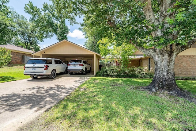2600 Boldt Ave, Tyler, TX 75701 - view of front of house featuring a front lawn, a carport, driveway, and brick siding