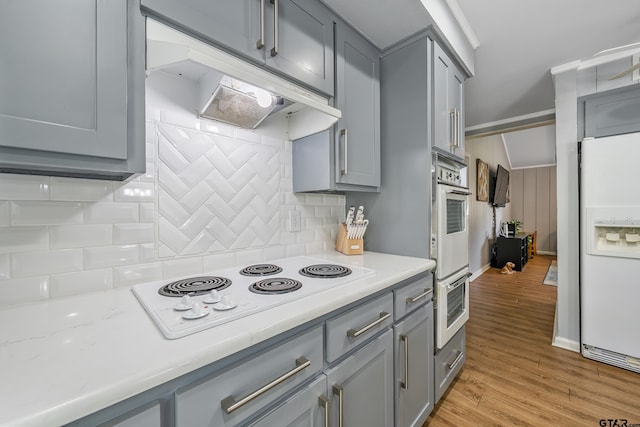 2600 Boldt Ave, Tyler, TX 75701 - kitchen with gray cabinetry, white appliances, under cabinet range hood, and light countertops