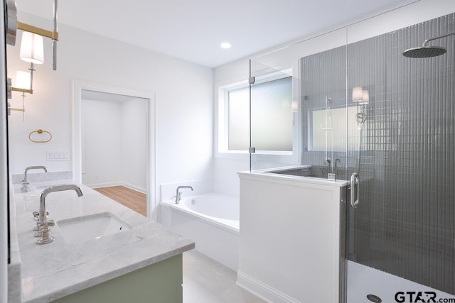 9244 Villas Ct, Tyler, TX 75703 - bathroom featuring a stall shower, double vanity, a bath, and recessed lighting