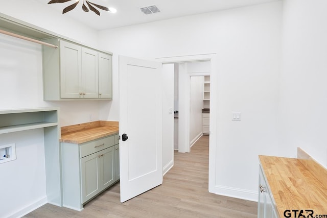 9244 Villas Ct, Tyler, TX 75703 - laundry room featuring cabinet space, washer hookup, light wood-style floors, and baseboards