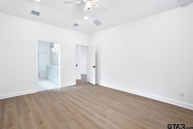 9244 Villas Ct, Tyler, TX 75703 - unfurnished bedroom featuring light wood finished floors, baseboards, ensuite bath, and ceiling fan