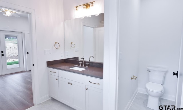 9244 Villas Ct, Tyler, TX 75703 - bathroom with vanity, toilet, baseboards, and ceiling fan