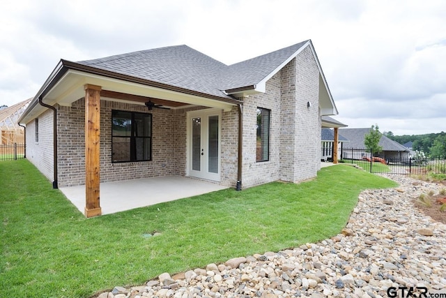 9244 Villas Ct, Tyler, TX 75703 - back of house with ceiling fan, brick siding, a patio, and roof with shingles