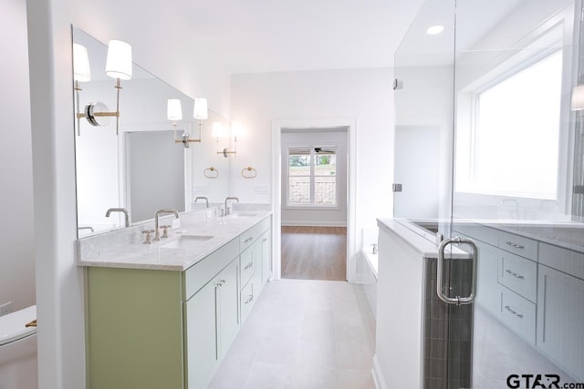 9244 Villas Ct, Tyler, TX 75703 - full bath featuring double vanity, a bath, toilet, tile patterned floors, and baseboards
