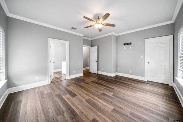 811 W 27th St, Tyler, TX 75702 - unfurnished bedroom featuring dark wood finished floors, ornamental molding, baseboards, and multiple windows