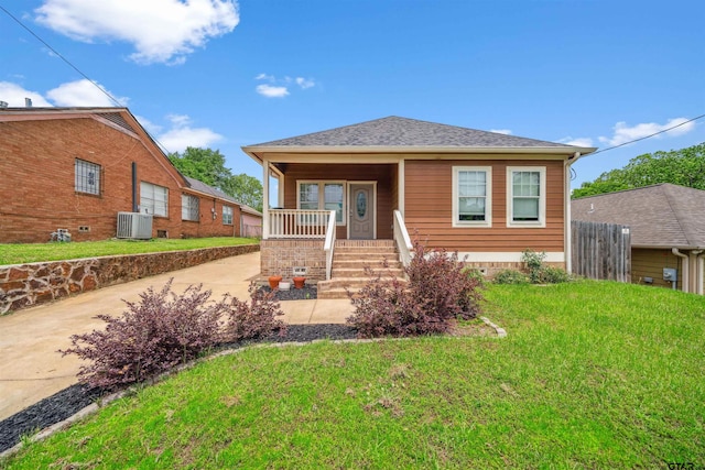 811 W 27th St, Tyler, TX 75702 - bungalow featuring a porch, cooling unit, and driveway