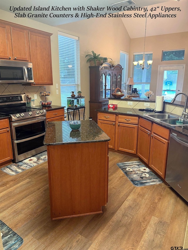 12260 Wild Horse, Tyler, TX 75706 - kitchen with light wood-style floors, stainless steel appliances, lofted ceiling, a chandelier, and backsplash
