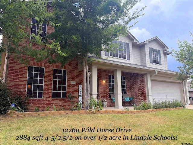 12260 Wild Horse, Tyler, TX 75706 - traditional-style home featuring brick siding, a porch, a garage, and a front yard