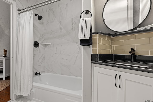 bathroom featuring vanity, decorative backsplash, and shower / tub combo