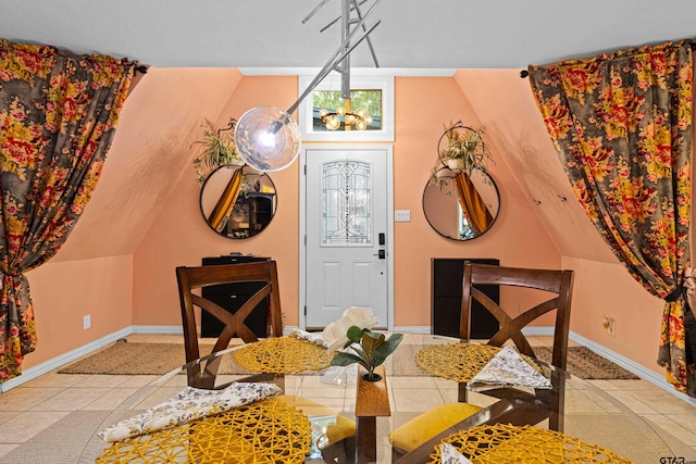 dining room featuring tile patterned floors, baseboards, and a chandelier