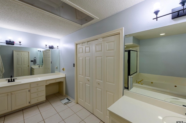 bathroom featuring vanity, a textured ceiling, tile patterned floors, and independent shower and bath