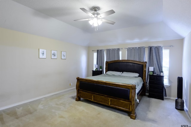 bedroom with light carpet, ceiling fan, and vaulted ceiling