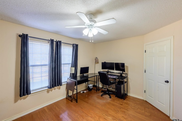 office space with ceiling fan, wood-type flooring, and a textured ceiling