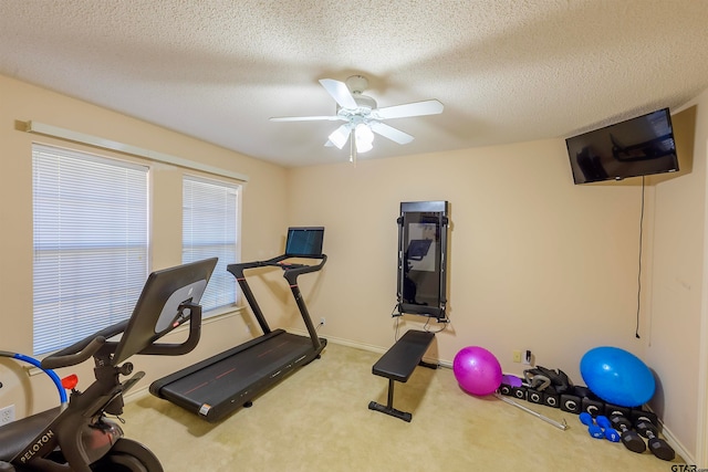 exercise area with carpet, a textured ceiling, and ceiling fan