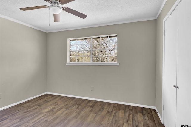 unfurnished bedroom featuring baseboards, wood finished floors, a textured ceiling, crown molding, and a closet